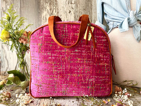Atenti Niki Bonnie with vivid pink textured velvet and brown handles.