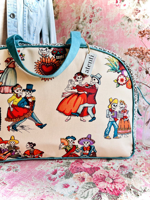 Handbag with colorful skeleton designs on a floral background