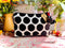 Black and white polka dot velvet pouch with red tassels 