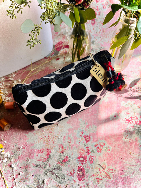 Black and white polka dot velvet pouch with red tassels 