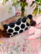 Black and white polka dot velvet pouch with red tassels 