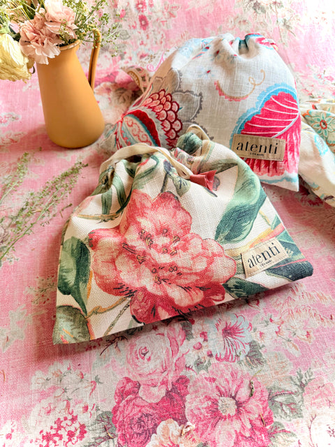 Atenti Assorted Drawstring Bags, Set of 4 with assorted decorative fabrics and drawstring closures.