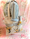 Beige tote bag with floral design on a floral background