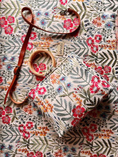 Handmade embroidered Wildflower Fifi tote bag with straw handles, detachable strap, and cream denim interior.
