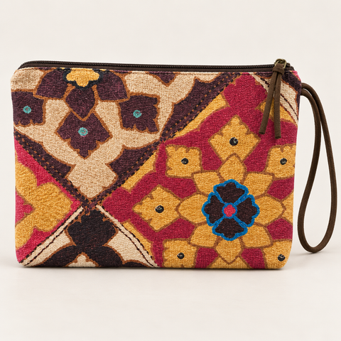 Reverse view of Atenti Fables Grand Pouch wristlet in raspberry, gold, cream and turquoise floral geometric fabric.