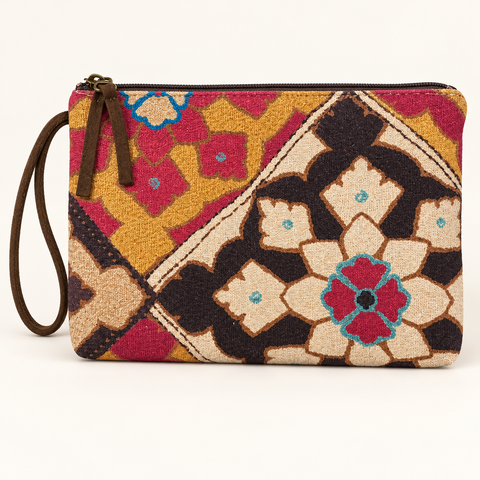Atenti Fables Grand Pouch wristlet with colorful geometric flowers, a brown zipper and a matching wrist loop, front view.