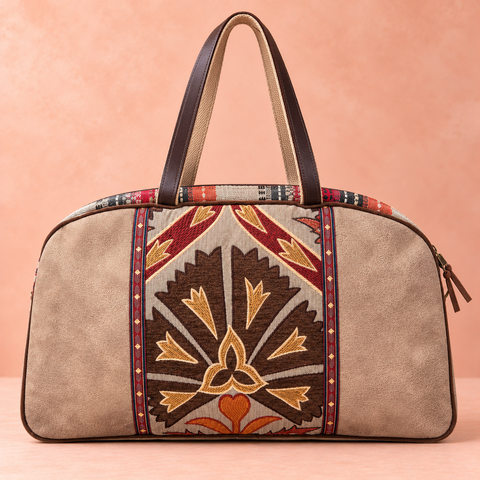 Tapestry patchwork Overnighter with brown, rust and gold patterned front panel, taupe panels and long brown shoulder handles