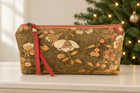 Atenti Woodland Bloom Tall Tool Pouch with cream flowers on olive fabric beside a decorated Christmas tree.