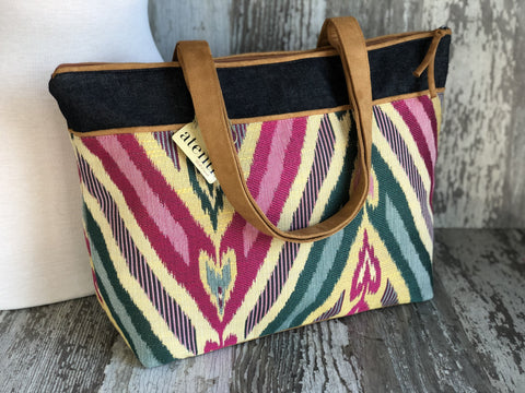 Atenti Sour Patch Satchel with multicolor geometric fabric, a dark upper band and long handles.